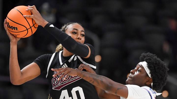 Mississippi State Bulldogs forward Madison Francis (40) is defended by Florida Gators guard Alexia Dizeko (9) Wednesday, March 4, 2026, during the SEC Women's Basketball Tournament first round game at Bon Secours Wellness Arena in Greenville, South Carolina.