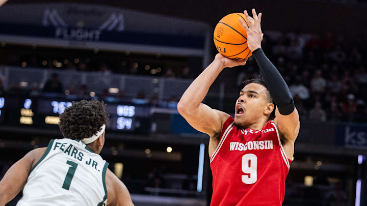 Mar 15, 2025; Indianapolis, IN, USA; Wisconsin Badgers guard John Tonje (9) shoots the ball while Michigan State Spartans guard Jeremy Fears Jr. (1) defends in the second half at Gainbridge Fieldhouse. Mar 15, 2025; Indianapolis, IN, USA; Wisconsin Badgers guard John Tonje (9) shoots the ball while Michigan State Spartans guard Jeremy Fears Jr. (1) defends in the second half at Gainbridge Fieldhouse.