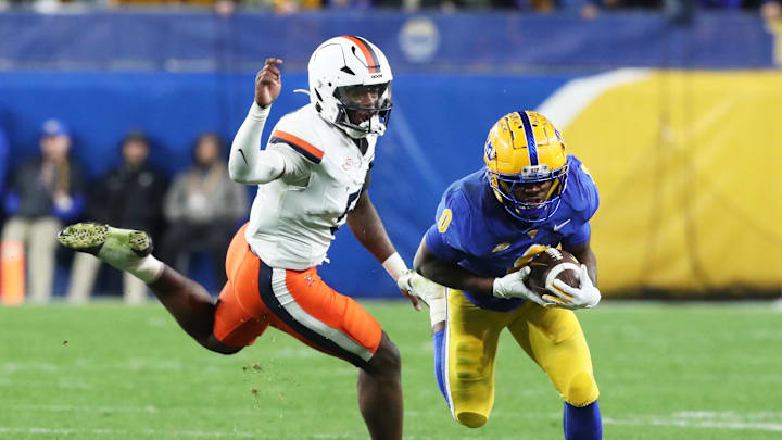 Nov 9, 2024; Pittsburgh, Pennsylvania, USA;  Pittsburgh Panthers running back Desmond Reid (0) runs after a catch against Virginia Cavaliers linebacker Kam Robinson (5) during the second quarter at Acrisure Stadium. Mandatory Credit: Charles LeClaire-Imagn Images