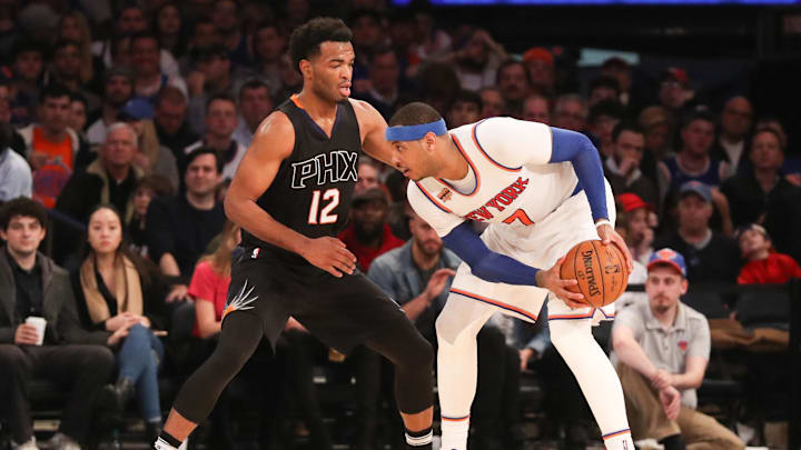 Jan 21, 2017; New York, NY, USA; Phoenix Suns forward TJ Warren (12) defends New York Knicks forward Carmelo Anthony (7) during the third quarter at Madison Square Garden. Phoenix Suns won 107-105. Mandatory Credit: Anthony Gruppuso-Imagn Images
