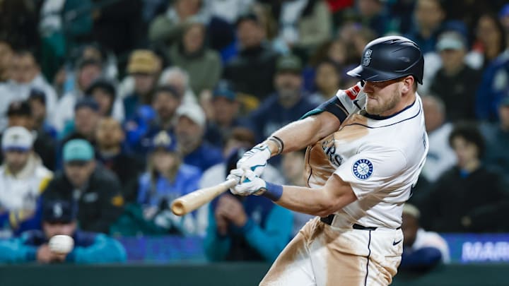 Seattle Mariners right fielder Luke Raley (20) hits an RBI-infield single against the Houston Astros during the seventh inning at T-Mobile Park on April 8. Seattle Mariners right fielder Luke Raley (20) hits an RBI-infield single against the Houston Astros during the seventh inning at T-Mobile Park on April 8.