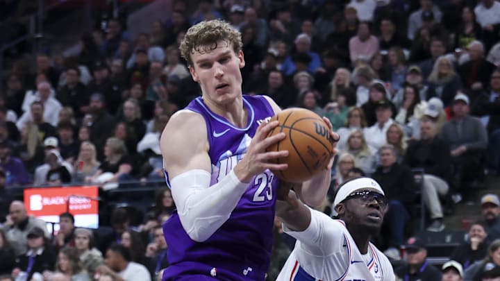 Dec 28, 2024; Salt Lake City, Utah, USA; Utah Jazz forward Lauri Markkanen (23) and Philadelphia 76ers guard Reggie Jackson (00) battle for a rebound during the third quarter at Delta Center. Mandatory Credit: Rob Gray-Imagn Images