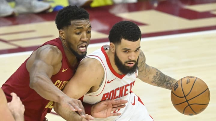 Jan 25, 2025; Cleveland, Ohio, USA; Cleveland Cavaliers guard Donovan Mitchell (45) defends against Houston Rockets guard Fred VanVleet (5) in the fourth quarter at Rocket Mortgage FieldHouse. Mandatory Credit: David Richard-Imagn Images