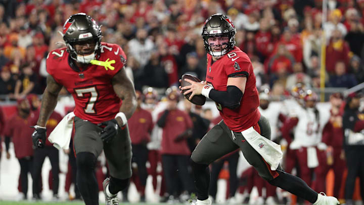 Jan 12, 2025; Tampa, Florida, USA; Tampa Bay Buccaneers quarterback Baker Mayfield (6) rolls out behind running back Bucky Irving (7)  during the third quarter of a NFC wild card playoff against the Washington Commanders at Raymond James Stadium. Mandatory Credit: Nathan Ray Seebeck-Imagn Images