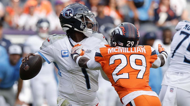 Denver Broncos cornerback Ja'Quan McMillian hits Tennessee Titans quarterback Cam Ward.