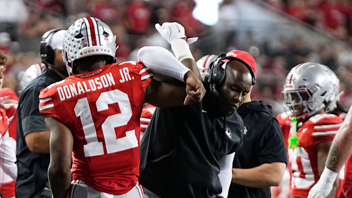 Ohio State Buckeyes running back CJ Donaldson Jr. (12) celebrates a touchdown with running backs coach Carlos Locklyn during the NCAA football game at Ohio Stadium in Columbus on Oct. 4, 2025.