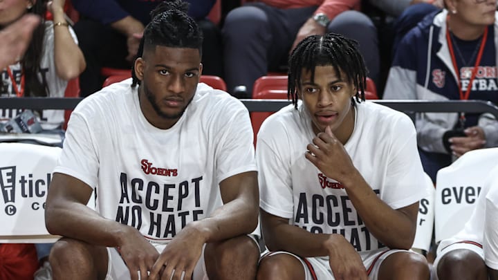 Nov 4, 2024; Queens, New York, USA;  St. John's basketball forward Zuby Ejiofor (24) and guard Simeon Wilcher (7) sit on the bench prior to the starting lineup introductions against the Fordham Rams at Carnesecca Arena