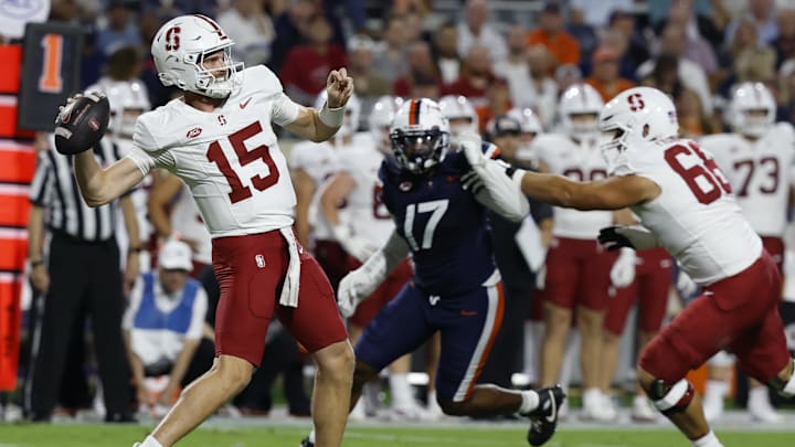 Sep 20, 2025; Charlottesville, Virginia, USA; Stanford Cardinal quarterback Ben Gulbranson (15) throws a sixty yard pass to Cardinal wide receiver Bryce Farrell (not pictured) as Virginia Cavaliers defensive end Mitchell Melton (17) defends during the first quarter at Scott Stadium. Mandatory Credit: Geoff Burke-Imagn Images