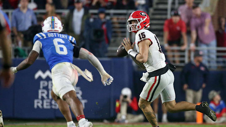 Nov 9, 2024; Oxford, Mississippi, USA; Georgia Bulldogs quarterback Carson Beck (15) rolls out to pass during the second half  against the Mississippi Rebels at Vaught-Hemingway Stadium. Mandatory Credit: Petre Thomas-Imagn Images