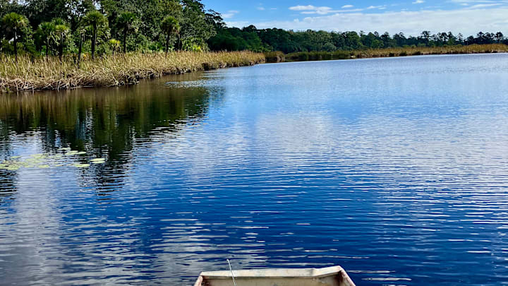 Fishing a bass pond from a jon boat. 