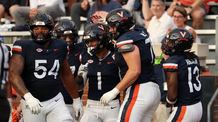 Sep 26, 2026; Charlottesville, Virginia, USA; Virginia Cavaliers wide receiver Rico Flores Jr. (1) celebrates with teammates after scoring a touchdown against the Delaware Blue Hens during the first half at Scott Stadium. Mandatory Credit: Geoff Burke-Imagn Images