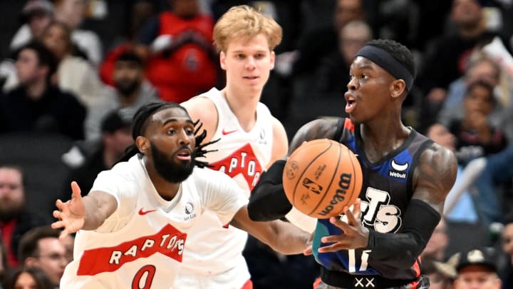 Mar 25, 2024; Toronto, Ontario, CAN;  Brooklyn Nets guard Dennis Schroder (17) passes against Toronto Raptors guards Javon Freeman-Liberty (0) and Gradey Dick (1) in the second half at Scotiabank Arena. Mandatory Credit: Dan Hamilton-USA TODAY Sports
