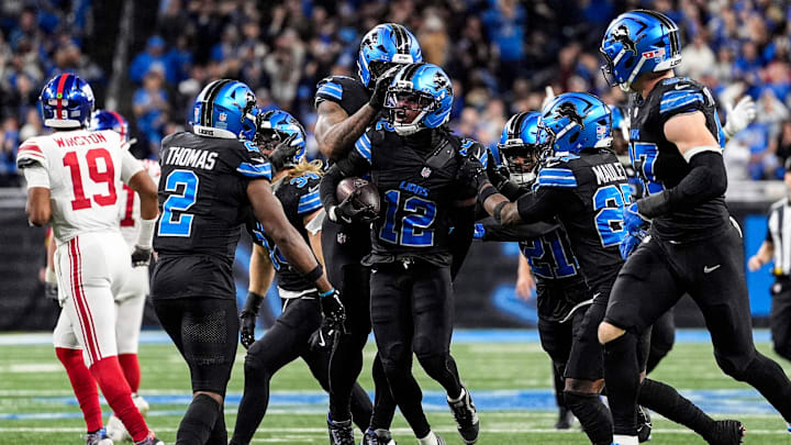 Detroit Lions safety Thomas Harper (12) celebrates an interception against New York Giants during the second half at Ford Field in Detroit on Sunday, Nov. 23, 2025.