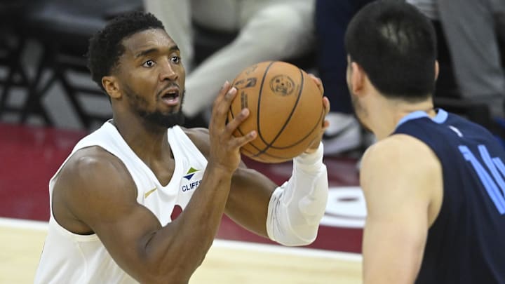 Nov 15, 2025; Cleveland, Ohio, USA; Cleveland Cavaliers guard Donovan Mitchell (45) looks to the basket beside Memphis Grizzlies center Zach Edey (14) in the third quarter at Rocket Arena. Mandatory Credit: David Richard-Imagn Images