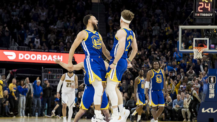 Jan 4, 2024; San Francisco, California, USA; Golden State Warriors guard Brandin Podziemski (2) celebrates with forward Klay Thompson (11) and guard Stephen Curry (30) after he scored against the Denver Nuggets during the second half at Chase Center. Mandatory Credit: John Hefti-Imagn Images