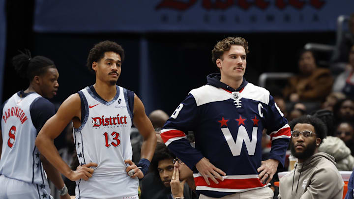 Dec 8, 2024; Washington, District of Columbia, USA; Washington Wizards guard Jordan Poole (13) and injured Wizards forward Corey Kispert (R) look on from the bench against the Memphis Grizzlies in the third quarter at Capital One Arena. Mandatory Credit: Geoff Burke-Imagn Images