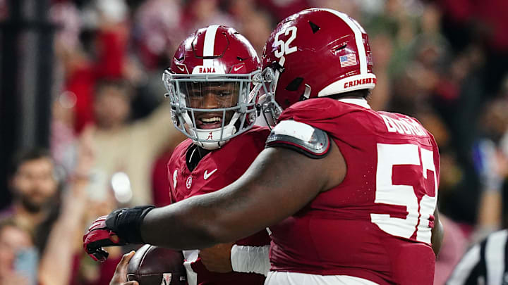 Nov 4, 2023; Tuscaloosa, Alabama, USA; Alabama Crimson Tide quarterback Jalen Milroe (4) celebrates his touchdown against the LSU Tigers with offensive lineman Tyler Booker (52) during the second half at Bryant-Denny Stadium. Alabama Crimson Tide defeated the LSU Tigers 42-28. Mandatory Credit: John David Mercer-Imagn Images