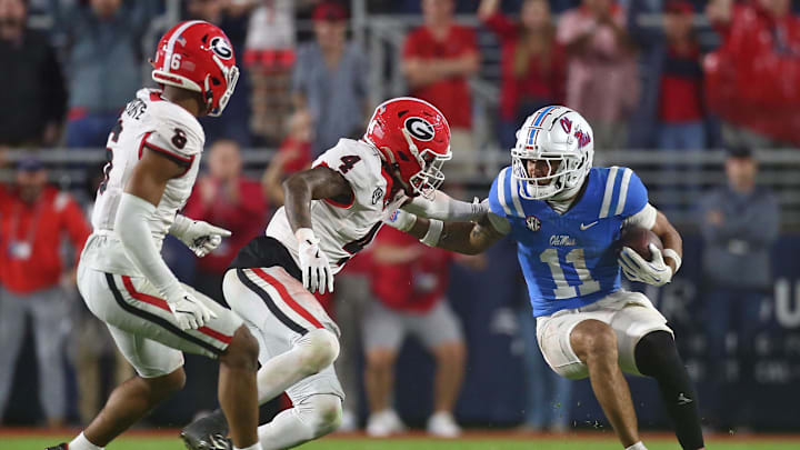 Nov 9, 2024; Oxford, Mississippi, USA; Mississippi Rebels wide receiver Jordan Watkins (11) runs after a catch as Georgia Bulldogs defensive back KJ Bolden (4) attempts to make the tackle during the second half  at Vaught-Hemingway Stadium. Mandatory Credit: Petre Thomas-Imagn Images