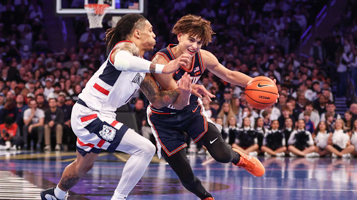 Nov 28, 2025; New York, New York, USA;  Illinois Fighting Illini guard Keaton Wagler (23) looks to drive past UConn Huskies guard Solo Ball (1) in the second half at Madison Square Garden. Mandatory Credit: Wendell Cruz-Imagn Images