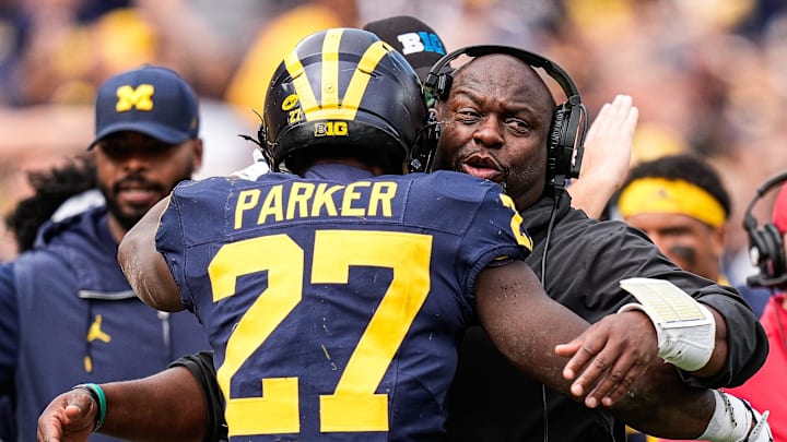 Michigan running backs coach Tony Alford hugs running back Jasper Parker (27) to celebrate his touchdown against Central Michigan during the second half at Michigan Stadium in Ann Arbor on Saturday, Sept. 13, 2025.