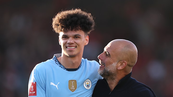 Nico O'Reilly receives congratulations from Pep Guardiola after his FA Cup performance.