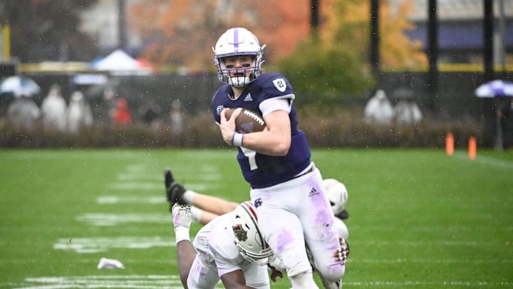 Quarterback Matt Sluka (9) dodges Lafayette defenders while scoring a touchdown for Holy Cross.