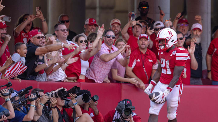 Oct 4, 2025; Lincoln, Nebraska, USA; Nebraska Cornhusker fans celebrate with running back Emmett Johnson (21) after a touchdown during the game against Michigan State at Memorial Stadium. Mandatory Credit: Kylie Graham-Imagn Images Oct 4, 2025; Lincoln, Nebraska, USA; Nebraska Cornhusker fans celebrate with running back Emmett Johnson (21) after a touchdown during the game against Michigan State at Memorial Stadium. Mandatory Credit: Kylie Graham-Imagn Images