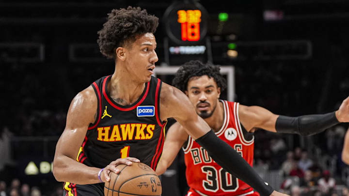 Dec 21, 2025; Atlanta, Georgia, USA; Atlanta Hawks forward Jalen Johnson (1) dribbles past Chicago Bulls guard Tre Jones (30) during the first half at State Farm Arena. Mandatory Credit: Dale Zanine-Imagn Images