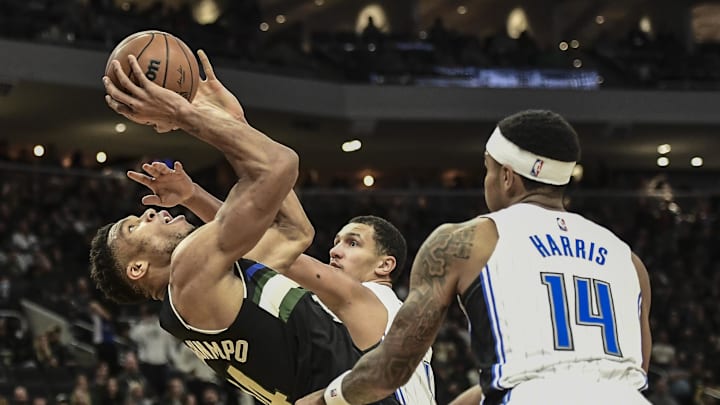 Nov 20, 2021; Milwaukee, Wisconsin, USA; Milwaukee Bucks forward Giannis Antetokounmpo (34) shoots the ball against Orlando Magic guard Jalen Suggs (4) and guard Gary Harris (14) in the first quarter at Fiserv Forum. Mandatory Credit: Benny Sieu-Imagn Images Nov 20, 2021; Milwaukee, Wisconsin, USA; Milwaukee Bucks forward Giannis Antetokounmpo (34) shoots the ball against Orlando Magic guard Jalen Suggs (4) and guard Gary Harris (14) in the first quarter at Fiserv Forum. Mandatory Credit: Benny Sieu-Imagn Images