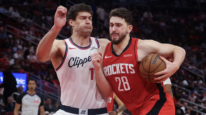 Feb 11, 2026; Houston, Texas, USA; Houston Rockets center Alperen Sengun (28) drives to the net against Los Angeles Clippers center Brook Lopez (11) in the second half at Toyota Center. Mandatory Credit: Thomas Shea-Imagn Images