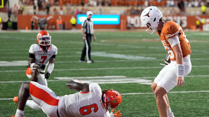 Sep 20, 2025; Austin, Texas, USA; Texas Longhorns quarterback Arch Manning (16) runs in for a touchdown past Sam Houston Bearkats linebacker Antivirus Fish (6) during the first half at Darrell K Royal-Texas Memorial Stadium. Mandatory Credit: Scott Wachter-Imagn Images