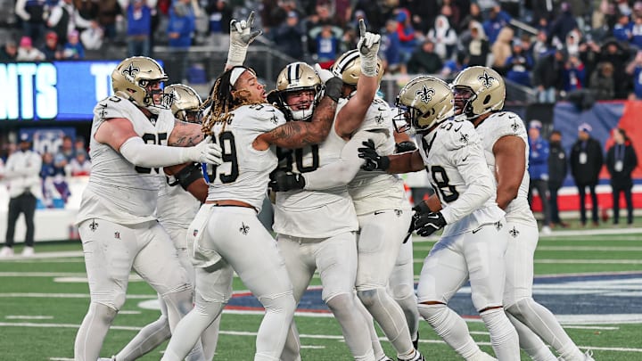 Dec 8, 2024; East Rutherford, New Jersey, USA; New Orleans Saints defensive tackle Bryan Bresee (90) celebrates with teammates after blocking a field goal during the fourth quarter by New York Giants place kicker Graham Gano (not pictured) at MetLife Stadium. Mandatory Credit: Vincent Carchietta-Imagn Images