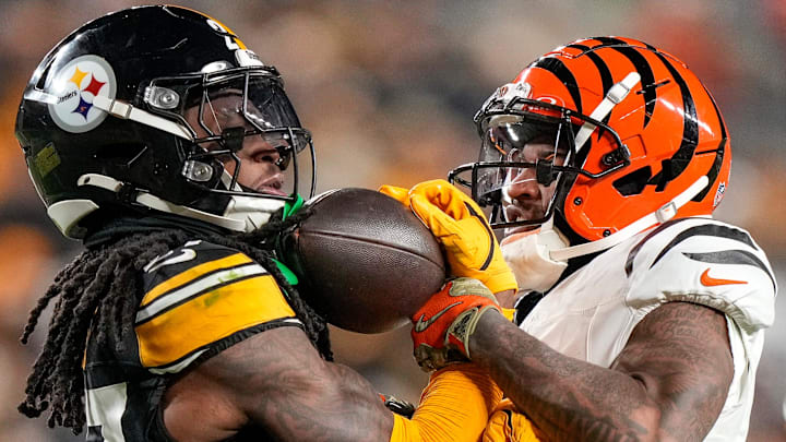 Pittsburgh Steelers cornerback Cory Trice Jr. (27) and Cincinnati Bengals wide receiver Ja'Marr Chase (1) tussle over a dead ball after a play in the second quarter of the NFL Week 18 game between the Pittsburgh Steelers and the Cincinnati Bengals at Acrisure Stadium in Pittsburgh on Saturday, Jan. 4, 2025.