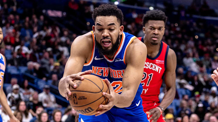 Dec 21, 2024; New Orleans, Louisiana, USA;  New York Knicks center Karl-Anthony Towns (32) grabs a rebound against New Orleans Pelicans center Yves Missi (21) during the second half at Smoothie King Center. Mandatory Credit: Stephen Lew-Imagn Images