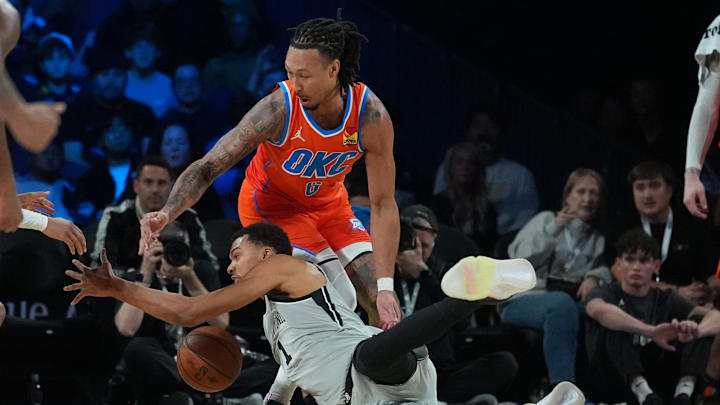 Dec 13, 2025; Las Vegas, Nevada, USA; Oklahoma City Thunder forward Jaylin Williams (6) and San Antonio Spurs forward Victor Wembanyama (1) battle for the loose ball during the second quarter at T-Mobile Arena. Mandatory Credit: Kirby Lee-Imagn Images