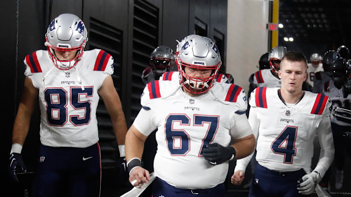 Dec 7, 2023; Pittsburgh, Pennsylvania, USA;  New England Patriots tight end Hunter Henry (85) and center Jake Andrews (67) and quarterback Bailey Zappe (4) take the field against the Pittsburgh Steelers at Acrisure Stadium. Mandatory Credit: Charles LeClaire-Imagn Images