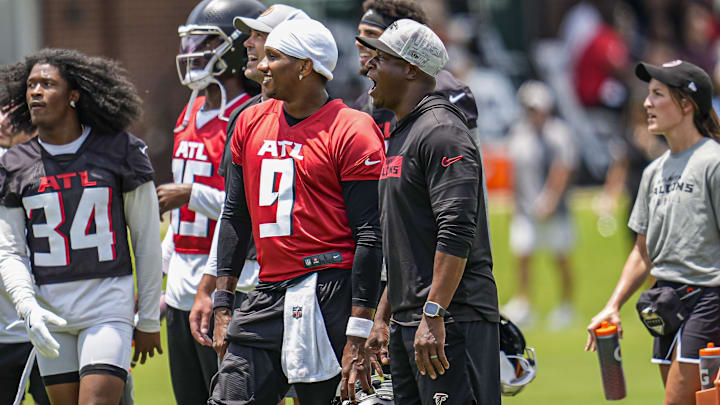 Jun 11, 2025; Atlanta, GA, USA; Atlanta Falcons quarterback Michael Penix Jr. (9) and head coach Raheem Morris on the field during Minicamp at Children's Healthcare of Atlanta Training Ground. Mandatory Credit: Dale Zanine-Imagn Images