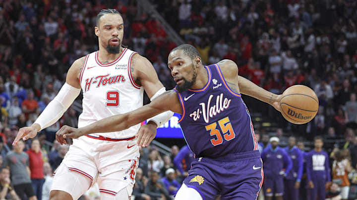Feb 23, 2024; Houston, Texas, USA; Phoenix Suns forward Kevin Durant (35) controls the ball as Houston Rockets forward Dillon Brooks (9) defends during the fourth quarter at Toyota Center. Mandatory Credit: Troy Taormina-Imagn Images