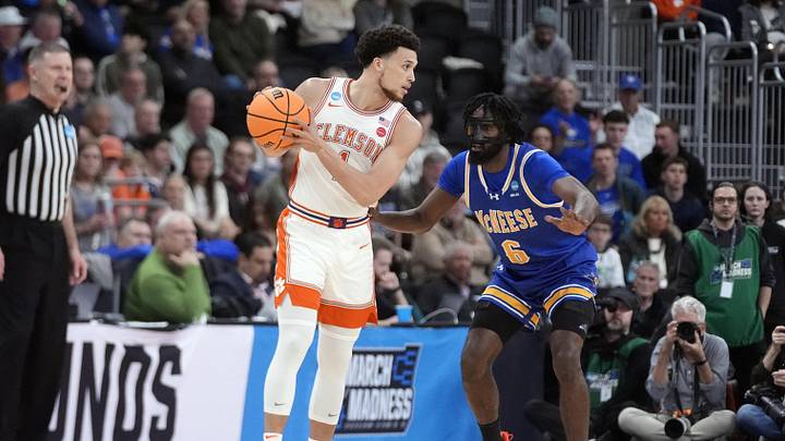 Mar 20, 2025; Providence, RI, USA; Clemson Tigers guard Chase Hunter (1) controls the ball against McNeese State Cowboys guard Javohn Garcia (6) during the first half at Amica Mutual Pavilion. Mandatory Credit: Gregory Fisher-Imagn Images