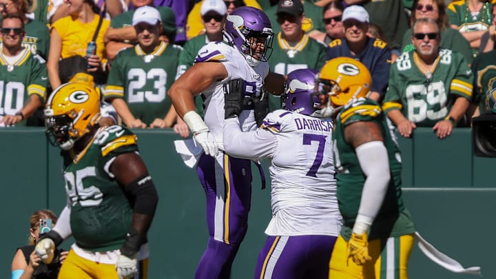 Minnesota Vikings tight end Josh Oliver (84) celebrates with offensive tackle Christian Darrisaw (71) after catching a touchdown pass against the Green Bay Packers on Sunday, September 29, 2024, at Lambeau Field in Green Bay, Wis. The Vikings won the game, 31-29. Minnesota Vikings tight end Josh Oliver (84) celebrates with offensive tackle Christian Darrisaw (71) after catching a touchdown pass against the Green Bay Packers on Sunday, September 29, 2024, at Lambeau Field in Green Bay, Wis. The Vikings won the game, 31-29.