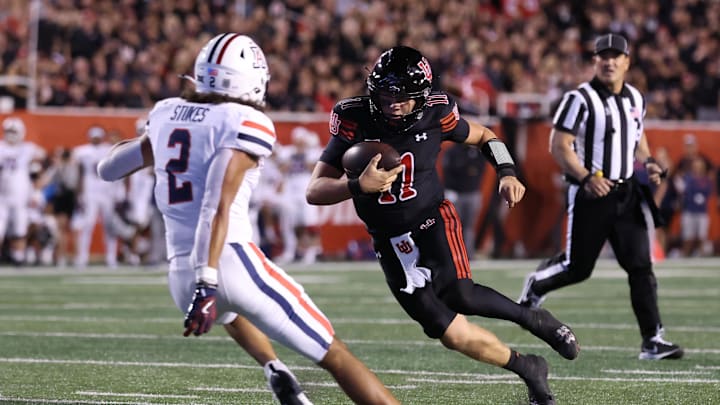 Sep 28, 2024; Salt Lake City, Utah, USA; Utah Utes quarterback Isaac Wilson (11) runs against Arizona Wildcats defensive back Treydan Stukes (2) during the second quarter at Rice-Eccles Stadium. Mandatory Credit: Rob Gray-Imagn Images