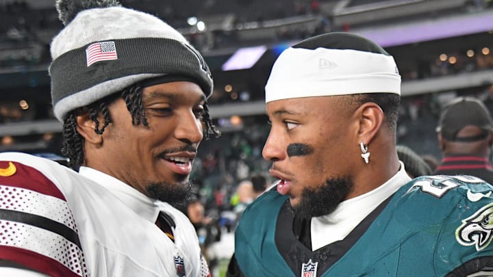 Nov 14, 2024; Philadelphia, Pennsylvania, USA; Washington Commanders quarterback Jayden Daniels (5) and Philadelphia Eagles running back Saquon Barkley (26) meet on the field after the game at Lincoln Financial Field. Mandatory Credit: Eric Hartline-Imagn Images
