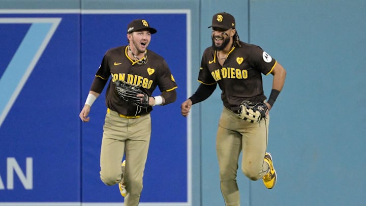 Oct 6, 2024; Los Angeles, California, USA; San Diego Padres outfielder Jackson Merrill (3) and outfielder Fernando Tatis Jr. (23) react in the sixth inning against the Los Angeles Dodgers during game two of the NLDS for the 2024 MLB Playoffs at Dodger Stadium. Mandatory Credit: Jayne Kamin-Oncea-Imagn Images