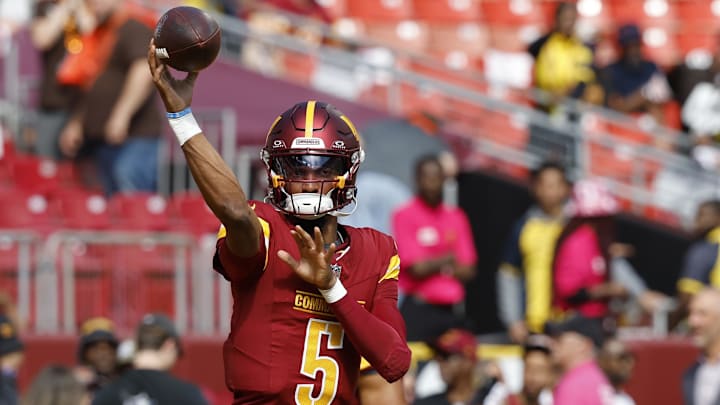 Oct 6, 2024; Landover, Maryland, USA; Washington Commanders quarterback Jayden Daniels (5) passes a ball during warmup prior to the game against the Cleveland Browns at NorthWest Stadium. Mandatory Credit: Geoff Burke-Imagn Images