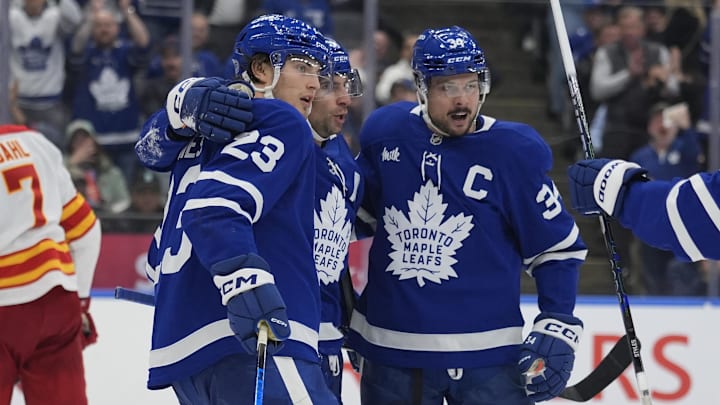 Oct 28, 2025; Toronto, Ontario, CAN; Toronto Maple Leafs forward John Tavares (91) and forward Auston Matthews (34) celebrate a goal by forward Matthew Knies (23) against the Calgary Flames during the third period at Scotiabank Arena. Mandatory Credit: John E. Sokolowski-Imagn Images Oct 28, 2025; Toronto, Ontario, CAN; Toronto Maple Leafs forward John Tavares (91) and forward Auston Matthews (34) celebrate a goal by forward Matthew Knies (23) against the Calgary Flames during the third period at Scotiabank Arena. Mandatory Credit: John E. Sokolowski-Imagn Images