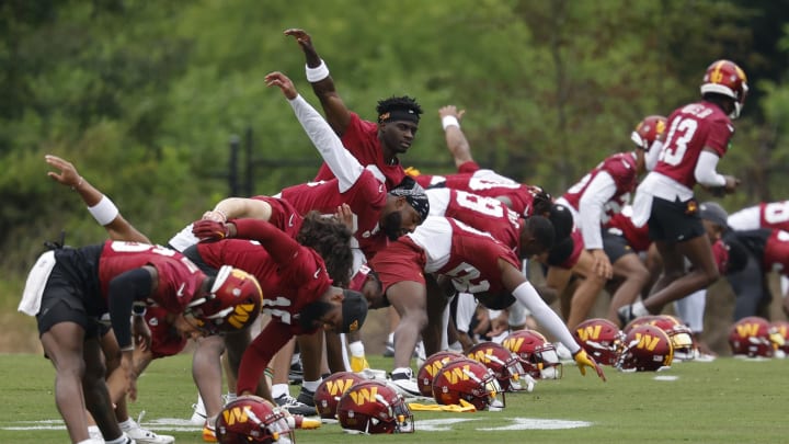 Jun 5, 2024; Ashburn, VA, USA; Washington Commanders players stretch prior to an OTA workout at Commanders Park. Mandatory Credit: Geoff Burke-USA TODAY Sports Jun 5, 2024; Ashburn, VA, USA; Washington Commanders players stretch prior to an OTA workout at Commanders Park. Mandatory Credit: Geoff Burke-USA TODAY Sports