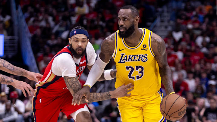 Apr 16, 2024; New Orleans, Louisiana, USA; Los Angeles Lakers forward LeBron James (23) dribbles against New Orleans Pelicans forward Brandon Ingram (14) during the second half of a play-in game of the 2024 NBA playoffs at Smoothie King Center. Mandatory Credit: Stephen Lew-Imagn Images