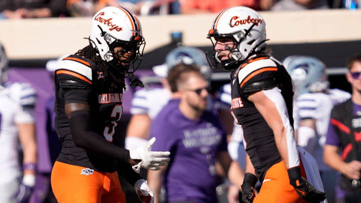 Oklahoma State's Cam Smith (3) and Parker Robertson (8) celebrate in the first half of the college football game between Oklahoma State University and the Kansas State Wildcats at Boone Pickens Stadium in Stillwater, Okla., Saturday Nov. 15, 2025.