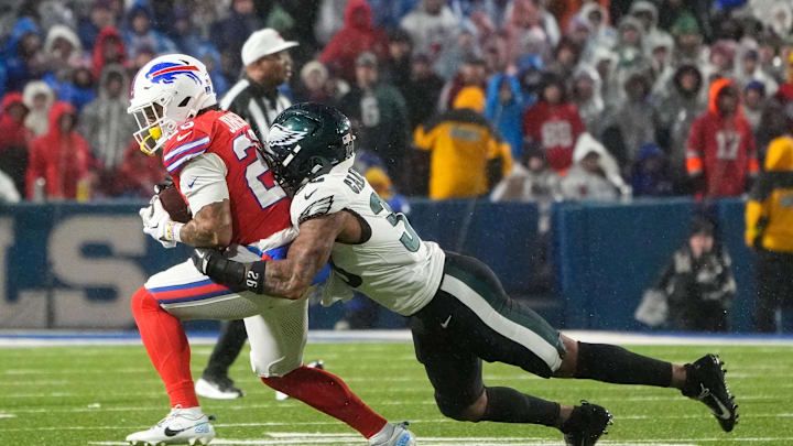 Dec 28, 2025; Orchard Park, New York, USA; Buffalo Bills running back Ty Johnson (26) runs the ball against Philadelphia Eagles cornerback Michael Carter II (35) during the third quarter at Highmark Stadium. 