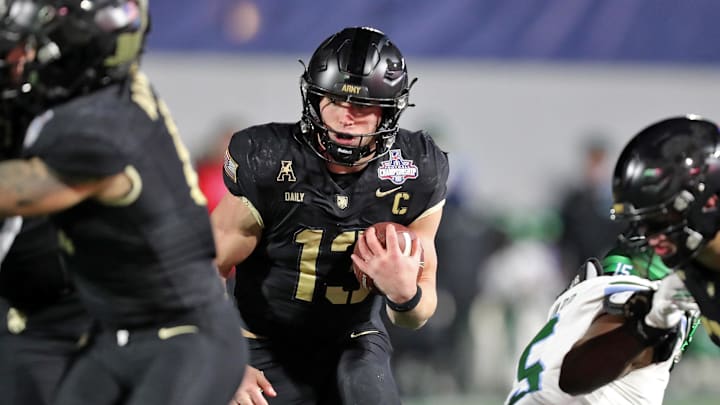 Dec 6, 2024; West Point, NY, USA; Army Black Knights quarterback Bryson Daily (13) carries the ball against the Tulane Green Wave during the first half at Michie Stadium. Mandatory Credit: Danny Wild-Imagn Images